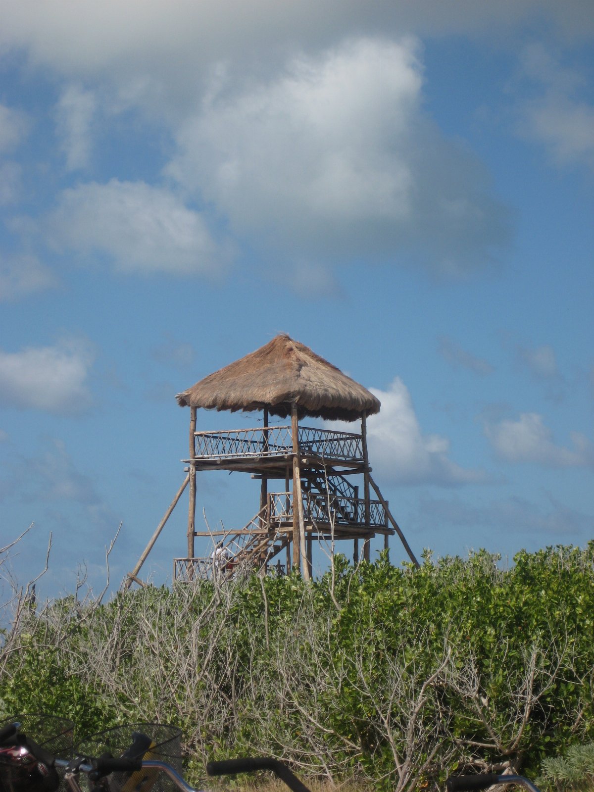 Blue Caribbean water and a thatched lookout on the coast of Cozumel